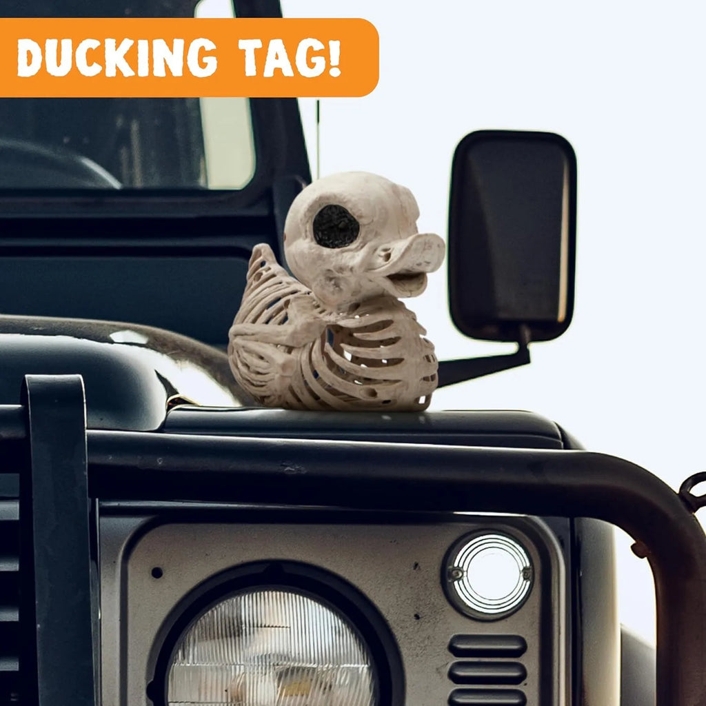 A skeleton duck sitting on a vehicle hood for a ducking game
