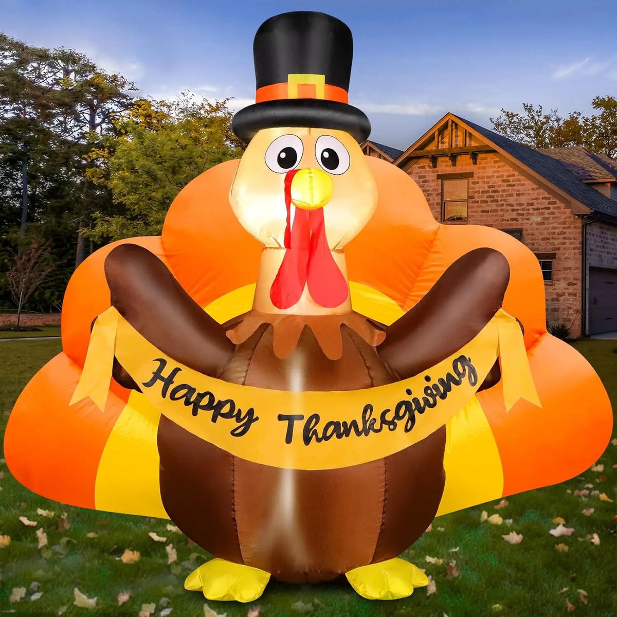 Pilgrim turkey inflatable holding a Happy Thanksgiving banner in a fall front yard