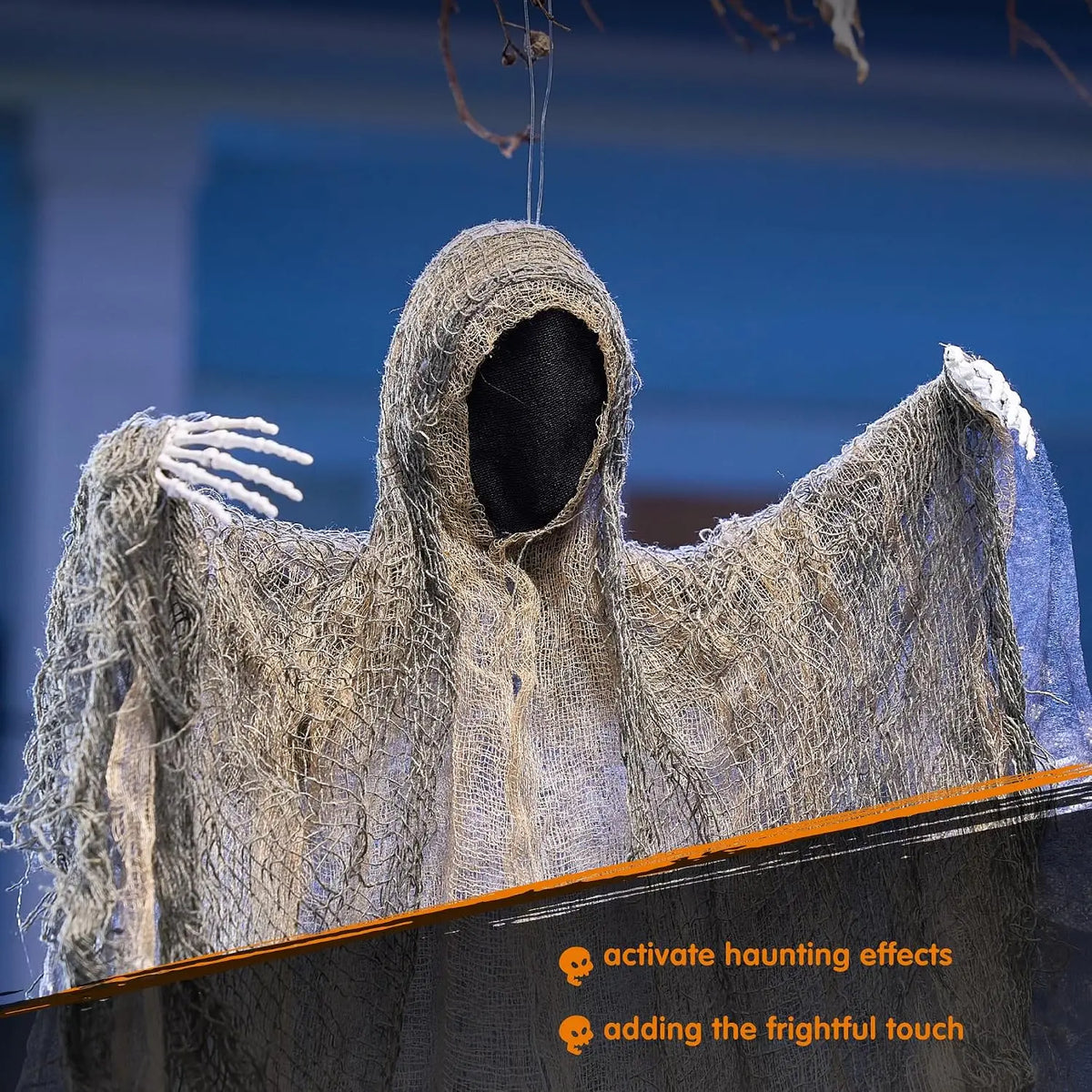 Faceless hanging ghost with skeleton hands hanging from a tree branch outdoors