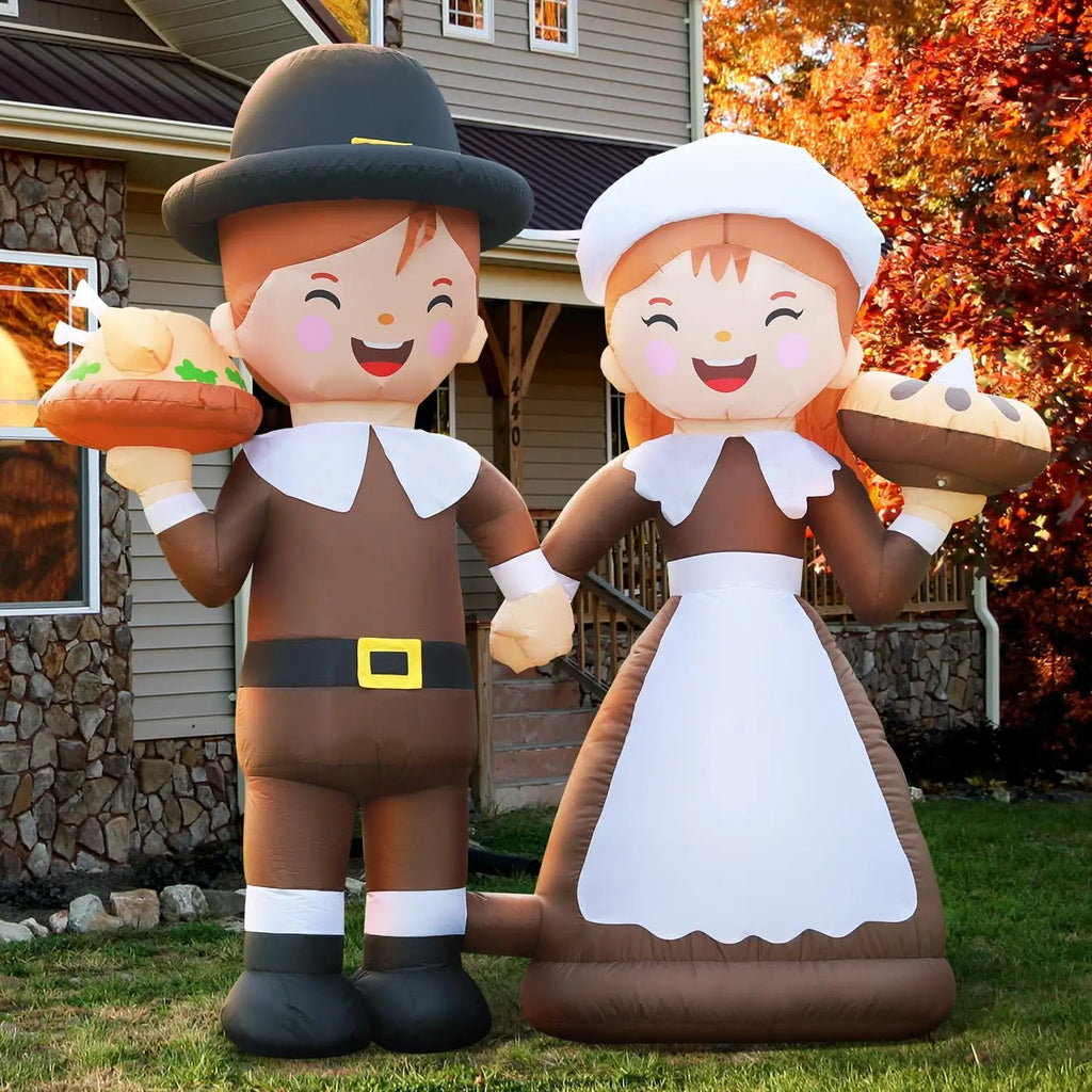 Thanksgiving pilgrim inflatable boy and girl holding a turkey and pie in a fall front yard