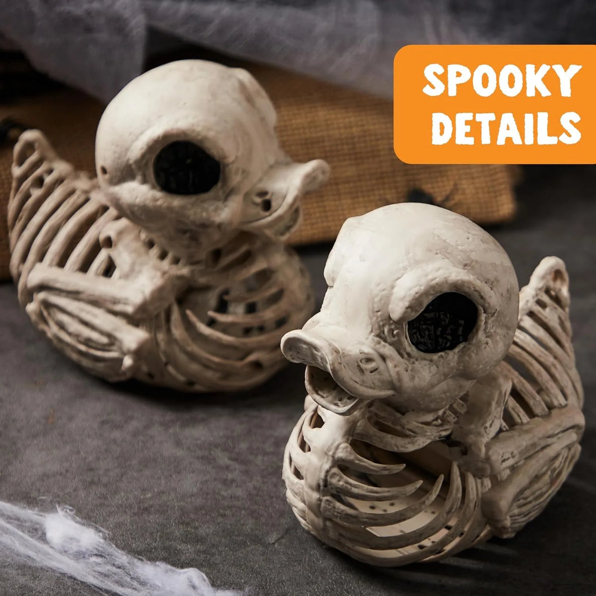 Two duck skeletons in a spooky Halloween scene
