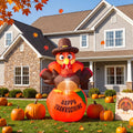 Giant inflatable turkey on pumpkin with Happy Thanksgiving lettering in a fall front yard